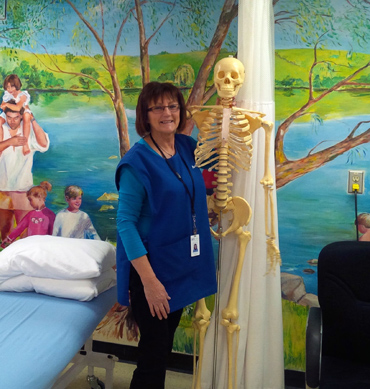 woman standing beside skeleton 
